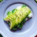 Delicious avocado toast with chia seeds and fresh tomatoes on a grey plate.